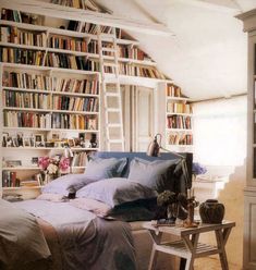 an attic bedroom with bookshelves full of books