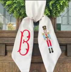 a pair of white scarfs decorated with nutcrackers and the letter b