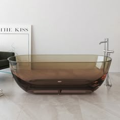 a glass bath tub sitting on top of a white floor