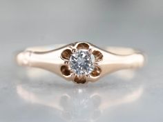 a gold ring with a diamond in the center