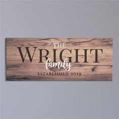 the wright family established sign hanging on a wall in front of a gray wall with wood planks