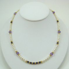 "This very pretty necklace is designed with white pearls, amethyst, purple velvet colored Swarovski Crystals, 18k Vermeil spacer beads, 24k Vermeil wire and a 24k Vermeil clasp.  The matching earrings are EV6.  Measures 18-1/2\" in length." Elegant Handmade Amethyst Pearl Necklace, Purple Pearl Single Strand Jewelry, Handmade Elegant Purple Pearl Necklace, Purple Pearl Single Strand Necklace, Elegant Single Strand Amethyst Beaded Necklace, Purple Single Strand Pearl Jewelry, Purple Pearl Jewelry With Gemstone Beads, Purple Single Strand Pearl Necklace, Gold Amethyst Single Strand Jewelry