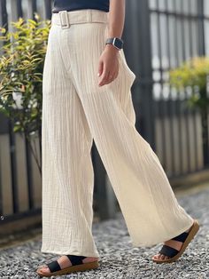 With a subtle texture unique to double gauze fabric, these pants exude a casual yet sophisticated look that can be dressed up or down. Side pockets add a functional touch, keeping essentials close at hand. Whether you're running errands, enjoying a day out, or unwinding after a long day, these muslin pants are your go-to choice for a blend of luxury and practicality. Pair them with a simple tee or a flowy blouse to complete your chic, laid-back ensemble. Size XS Waist 26 Hip 36" Long 38" Size S Elegant Cotton Beach Pants, Spring Cotton Bottoms With Crinkle Texture, Spring Wide-leg Crinkle Texture Pants, Spring Wide-leg Pants With Crinkle Texture, Chic Beige Ankle-length Harem Pants, Elegant Wide Leg Beach Trousers, Elegant Cotton Beach Bottoms, Elegant Cream Bottoms For Beach, Elegant Cream Beach Bottoms