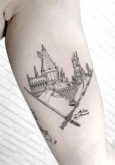 a black and white photo of a castle tattoo