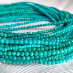 turquoise beads are stacked on top of each other