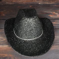 Black Glitter with Rhinestone Band Cowboy Hat. This cowboy hat is the perfect addition to your party, events, and even cute photos! This is an adult-sized, polyester cowboy hat sealed in glitter with a single rhinestone band. The glitter is only on the top of the hat ensuring that it will not get in your hair! The bottom of the hat is black matching the glitter color. The hat circumference is 23 inches. Keep in mind that this is not a fitted cowboy hat, one size fits most but it ranges on the larger size. The glitter has been sealed so it will not easily come off! We hope you will love this stunning hat as much as we do! You can customize this hat with any color glitter you want just message us or put it in the personalization section! Please message us if you have any questions or are int Cheap Black Costume Hats For Party, Affordable Party Cowboy Hat, Black Sparkly Cowboy Hat, Black Glitter Cowboy Hat, Luxury Black Hat With Rhinestones, Sparkly Cowboy Hat, Cowboy Hut, Felt Cowboy Hats, Chapeau Cowboy