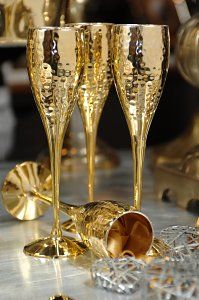 three champagne flutes sitting on top of a table