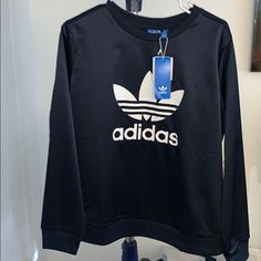 Nwt Adidas Navy Blue Silky Pullover Sweatshirt Limited Edition Size L New With Tags Never Worn 93% Polyester 7% Spandex Has A Small Hole On The Neck Where The Sensor Was..Took This On A Trip And They Unfortunately Left It On We Couldn’t Get It Off So The Flight Had To Cut It Or Else We Would’ve Had To Throw It Away :/ (Seen In 4th Pic Of The Back Of The Sweater Zoom In On The Neck Band Very Small And Hardly Noticeable) -Price Reflects Because Of This Blue Stretch Sweatshirt In Sportswear Style, Navy Long Sleeve Top For Athleisure, Casual Navy Adidas Top, Blue Stretch Sweatshirt In Sporty Style, Blue Crew Neck Athleisure Sweater, Adidas Blue Sweatshirt For Fall, Sporty Navy Adidas Tops, Adidas Navy Sporty Tops, Adidas Stretch Long Sleeve Tops