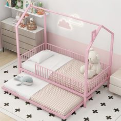 a child's bed with a pink frame and mattress in the middle, next to a white teddy bear