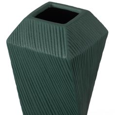 a large green vase sitting on top of a white table