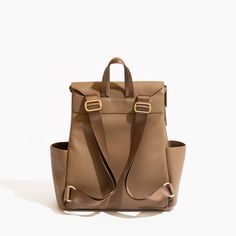 a brown leather backpack with two straps on the front and side pockets, sitting against a white background