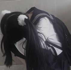 a woman with long black hair wearing a backpack