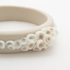 a white bracelet with flowers on it