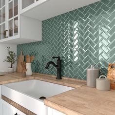 a kitchen with green tiles on the backsplash and wooden counter tops, along with white cabinets