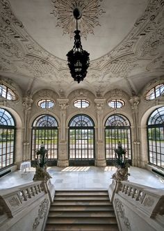 an ornately decorated building with many windows and chandelier hanging from the ceiling