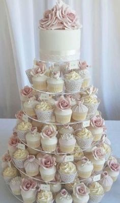 a wedding cake made out of cupcakes on a table