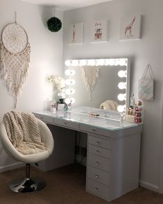 a vanity with lights and a chair in front of it