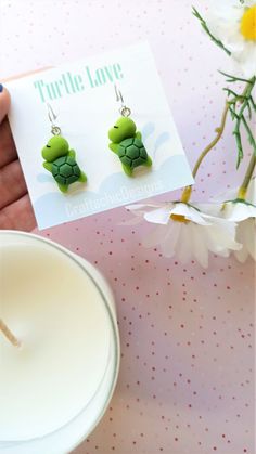 Super cute Turtle earrings, made from resin, in green colors. The closure is leverback, which is very comfortable and easy to wear, just click the back up and you're ready to show them off. The leverback makes sure the earrings will not fall out of your ear and it doesn't require additional pieces to make them secure. Packaging Materials: cardstock backing, holographic ziplock Size: 4 cm (total lenght) 1.5 cm (width) Find Me Here: Facebook: https://www.facebook.com/craftachicdesigns Instagram: h Whimsical Green Nickel-free Jewelry, Cute Everyday Green Jewelry, Cute Green Everyday Earrings, Cute Handmade Green Jewelry, Cute Everyday Green Earrings, Cute Green Earrings For Everyday, Cute Resin Jewelry With Matching Earrings, Green Playful Earrings, Playful Green Polymer Clay Jewelry