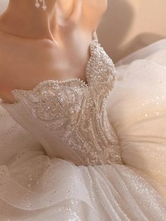 the back of a wedding dress with beading on it, as seen from behind