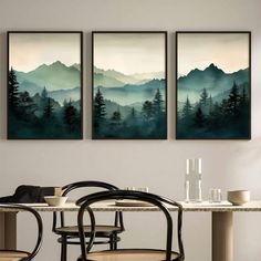 three paintings hanging on the wall above a dining room table with chairs and a vase