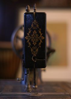 an old fashioned sewing machine sitting on top of a table