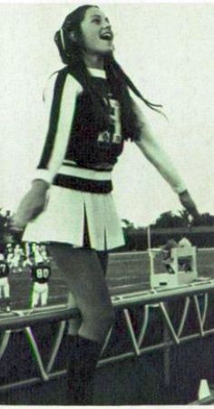 an old photo of a cheerleader on the sidelines