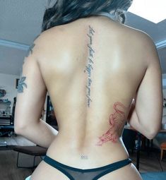 the back of a woman's body with tattoos on her upper and lower back