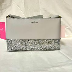 Measurements 9.6" W X 5.8" H X 1.4" D Features Strap Drop: 22" Dust Bag Included: No Interior: Front Credit Card Slots And Back Slip Pocket Materials: Glitter Fabric Trim: Saffiano Pvc Trim Imported Style Number K8711 Color: Light Grey Kate Spade Crossbody Party Bag, Kate Spade Crossbody Bag For Party, Elegant Kate Spade Glitter Bags, Chic Kate Spade Party Bags, Kate Spade Silver Bag For Everyday Use, Kate Spade Silver Bag For Everyday, Kate Spade Silver Everyday Bag, Silver Kate Spade Bag For Everyday, Kate Spade Disney