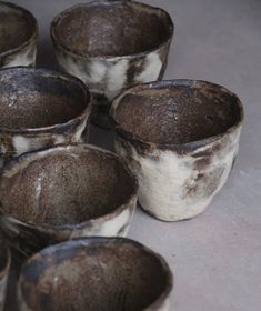 several brown and white cups sitting next to each other