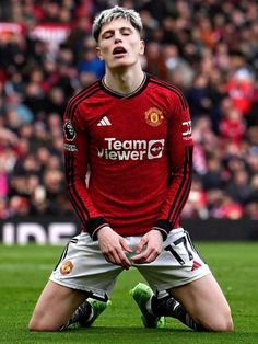 a man sitting on top of a soccer field