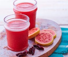 two glasses of watermelon juice on a wooden tray