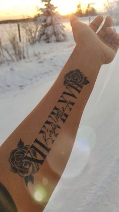 a person with a tattoo on their arm in the snow