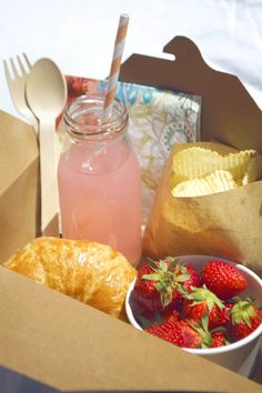 a box filled with food and drinks on top of a table