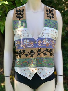 this is a vintage boho embroidered vest  by the looks of the tag this is from the 90s the material is made of a cotton/linen blend the material itself is lightweight and breathable, making it suitable for warmer weather  Tag size is medium measurements as follows: pit to pit laying flat is 18.5" inches  length is 22.5" at the point in front  vest is excellent shape! I haven't noticed any flaws  I ship priority mail with tracking! Thanks for looking :) Bohemian Embroidered Cotton Tank Top, Bohemian Cotton Embroidered Tank Top, Embroidered Cotton Tank Top For Beach, Fitted Embroidered Tank Top For Beach, Bohemian Tank Top With Floral Embroidery, Fall Embroidered Cotton Vest, Fall Cotton Embroidered Vest, Embroidered Tank Top For Festivals, Fitted Cotton Tank Top With Floral Embroidery