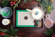 a tray with cookies, marshmallows, and other holiday treats on it