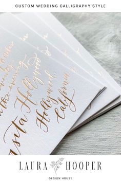 four wedding calligraphy style envelopes with gold foil lettering on the front and back