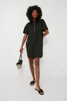 We tasked ourselves with giving the classic shirtdress a refresh, and this is the fabulous result. Keeping it simple yet elevated, the Black Oakley Dress is the definition of effortlessly chic. In a crisp cotton fabric that will drape perfectly and keep you feeling good no matter the weather, this mini features a sophisticated point collar, gold snaps down the partial placket and at the hip pockets, and a rounded hem. Wearable for nearly any occasion, this silhouette can do office days with loaf Black Relaxed Fit Shirt Dress For Work, Black Relaxed Fit Cotton Shirt Dress, Black Cotton Shirt Dress With Relaxed Fit, Chic Black Shirt Dress With Relaxed Fit, Black Cotton Relaxed Fit Shirt Dress, Chic Black Relaxed Fit Shirt Dress, Chic Cotton Business Casual Dress, Collared Shift Shirt Dress For Work, Chic Cotton Dresses For Business Casual