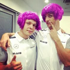 two men with purple hair posing for a photo