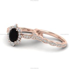 a rose gold ring with an oval black stone surrounded by diamonds