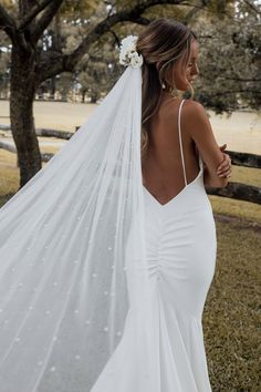 a woman wearing a wedding dress and veil