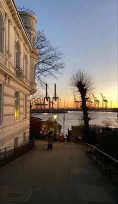 the sun is setting behind an old building and some people are sitting on their bikes