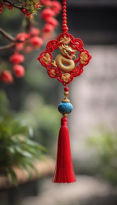 a red and gold dragon decoration hanging from a tree