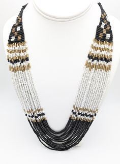 Black and white waterfall necklace. Multi strand, torsade necklace.  Glass seed beads. 16 strands. Adjustable length. 24 to 27 inches.  This has never been worn. NOS New old stock.  To continue shopping in my store, click the link below: https://www.etsy.com/shop/MagicOfLee Multi-strand Beaded Necklaces, White Multi-strand Beaded Necklaces, White Multi-strand Beaded Necklace, Bohemian White Multi-strand Layered Necklace, Multi-strand Beaded Necklace With Large Beads, White Multi-strand Beaded Necklace With Large Beads, Adjustable Multi-strand Beaded Necklaces, Adjustable White Beaded Layered Necklace, White Multi-strand Bohemian Beaded Necklaces