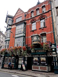 an old brick building with flower boxes on the front