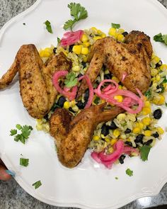 a white plate topped with chicken and vegetables