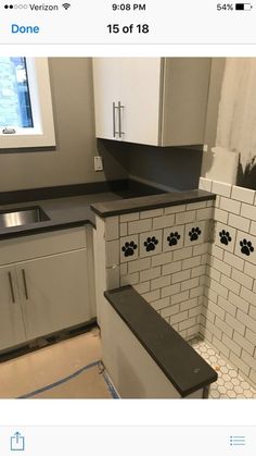 a dog paw print on the backsplash of a kitchen