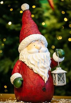 a santa clause figurine holding a lantern