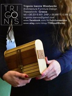 a woman holding a wooden box with the words trigonia lonnii wood works on it