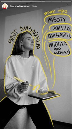 a woman sitting on top of a couch next to a wall covered in graffiti and writing