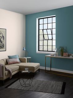 a living room with blue walls and wood floors